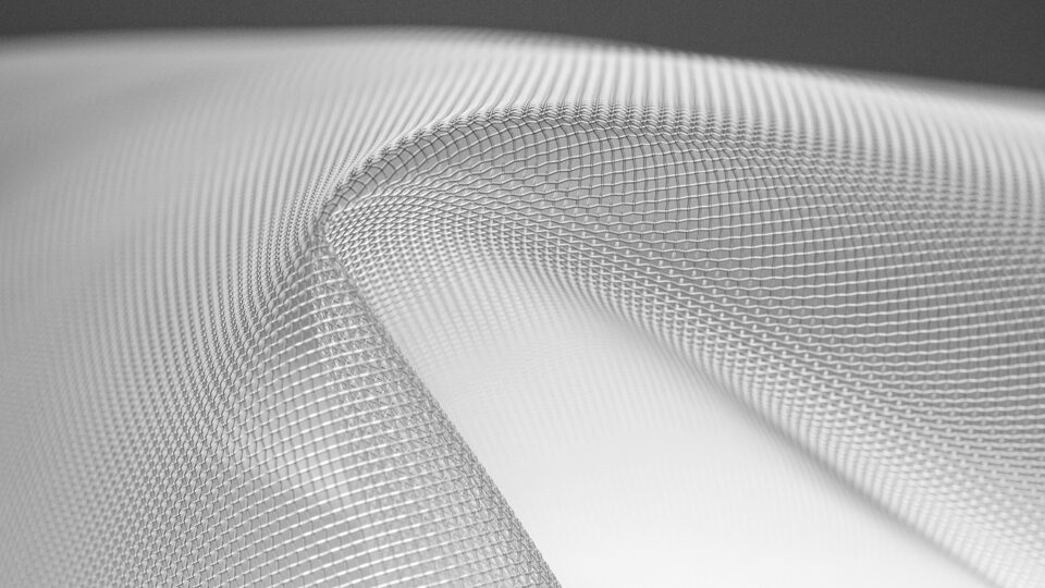 Close-up of fine mesh fabric forming smooth curved folds in grayscale imagery.
